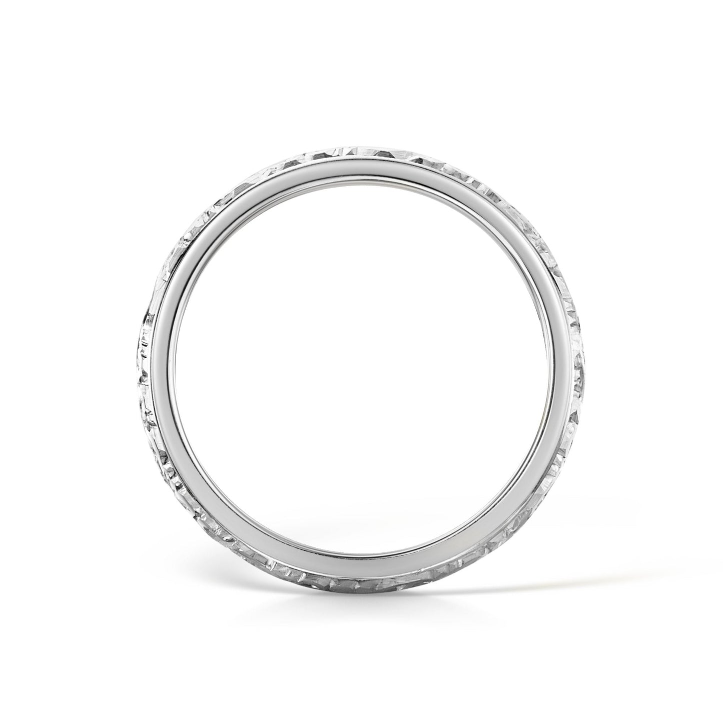 Side view of scroll engraved white gold wedding band