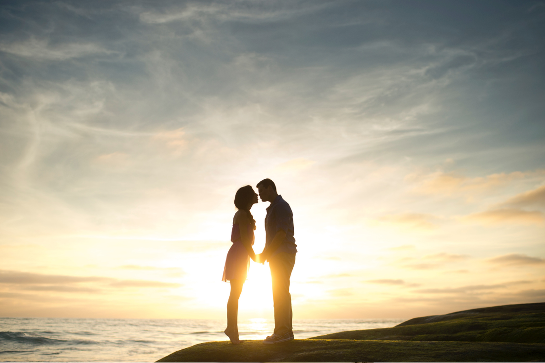 Couple after surprise proposal on the beach, with bespoke engagement ring