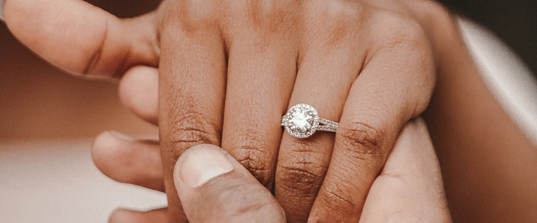 Bespoke Engagement Ring on a hand which is being held.