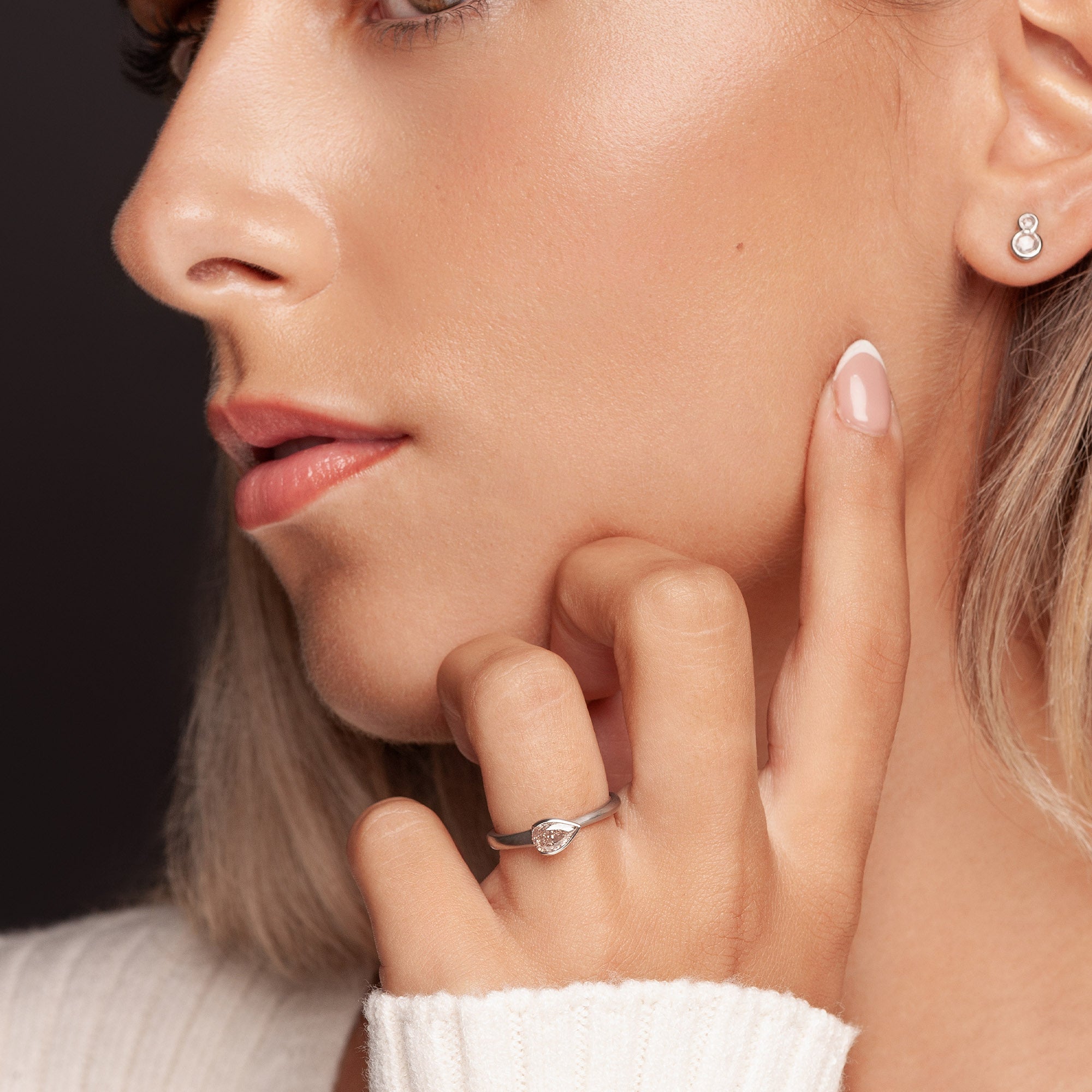 Fancy pink diamond engagement ring on model’s hand