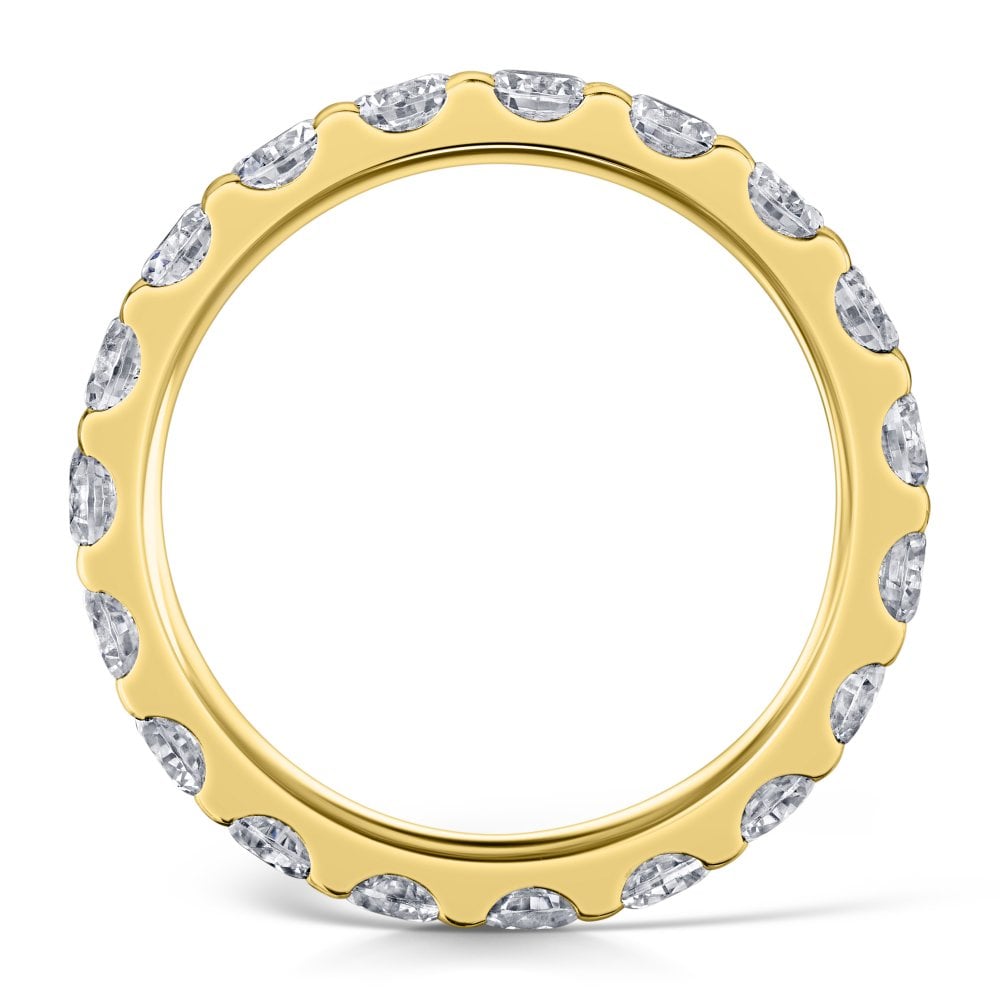 3mm claw set diamond eternity ring in yellow gold - Side view on a white background