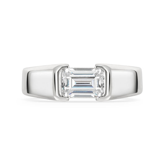 Chunky platinum emerald cut diamond east west diamond ring on a white background