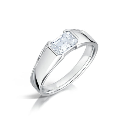 A chunky emerald cut diamond engagement ring with a platinum band, displayed against a white background.