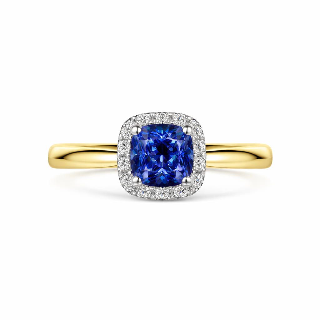 Gold ring with a blue Sapphire and diamond halo on a white background