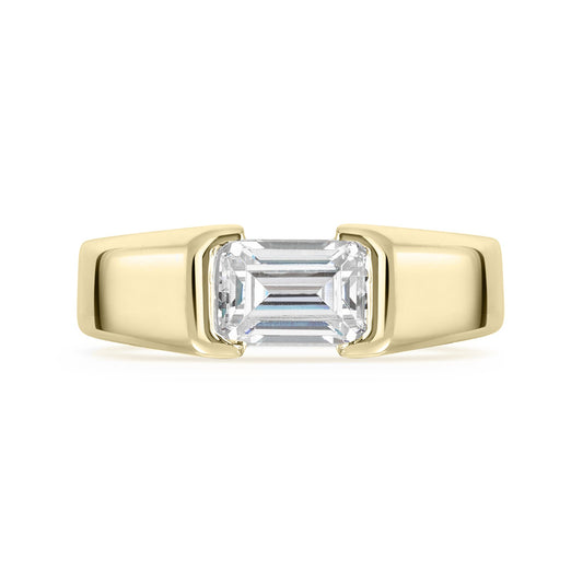 Gold ring with a rectangular diamond on a white background
