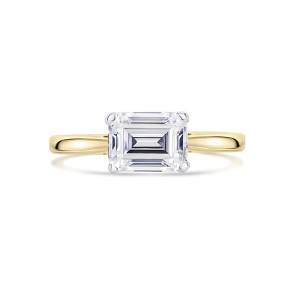 East West Emerald Cut Diamond Engagement Ring in Yellow Gold on a white background