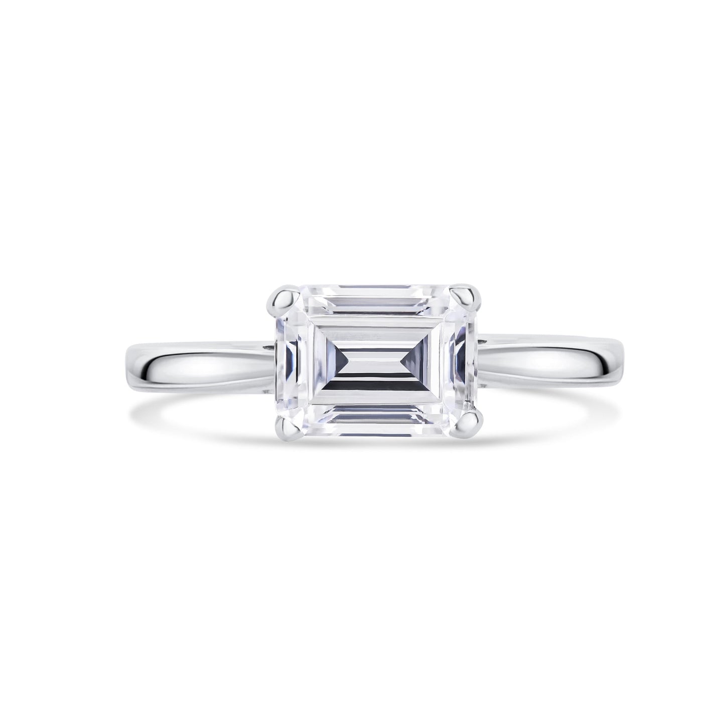 Diamond ring with emerald-cut diamond set across on a white background