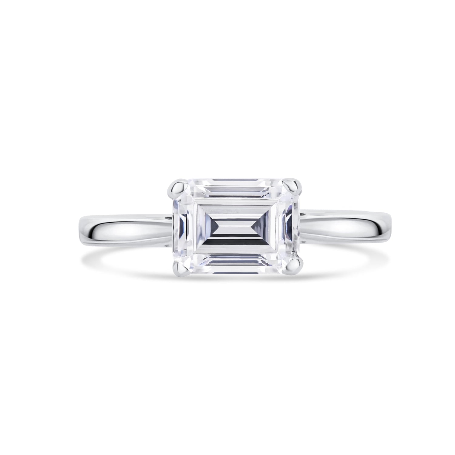 Diamond ring with emerald-cut diamond set across on a white background