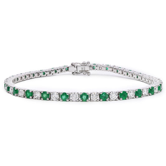 Emerald and Diamond Tennis Bracelet with alternating stones and white background
