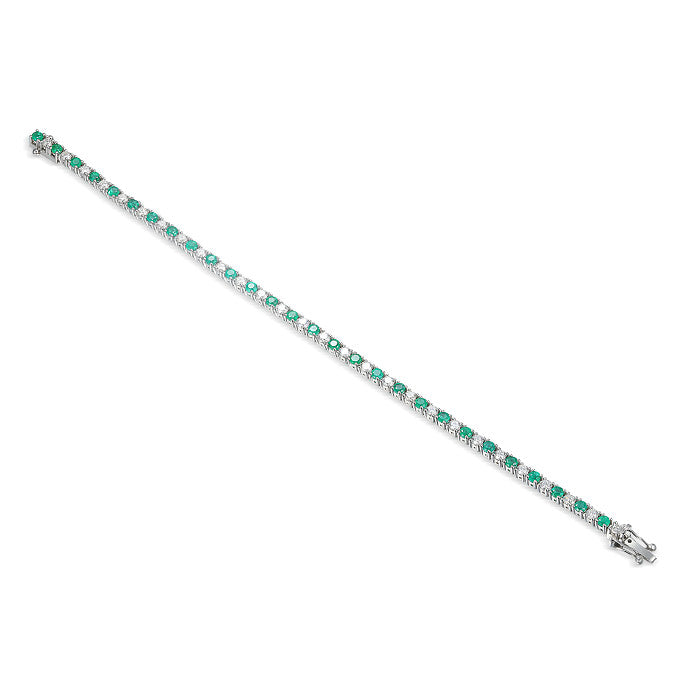 Emerald and Diamond Tennis Bracelet with claw setting on white background