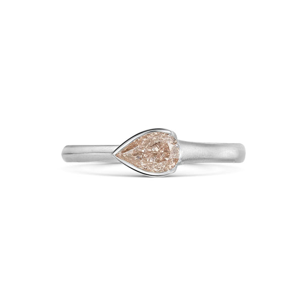 Natural Fancy Pink Pear Shaped Diamond Set in a Platinum Band on white background