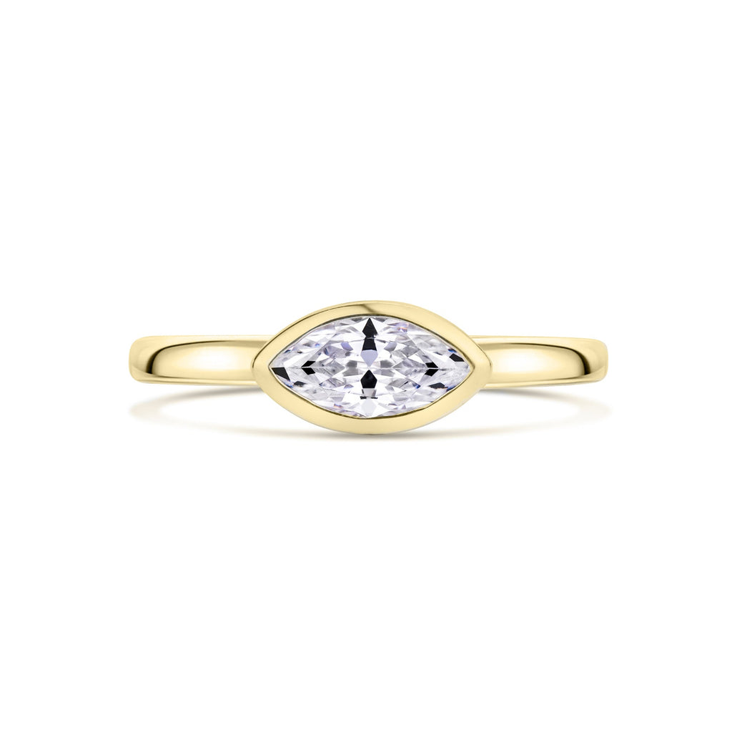 Gold ring with a marquise-shaped diamond set East West on a white background