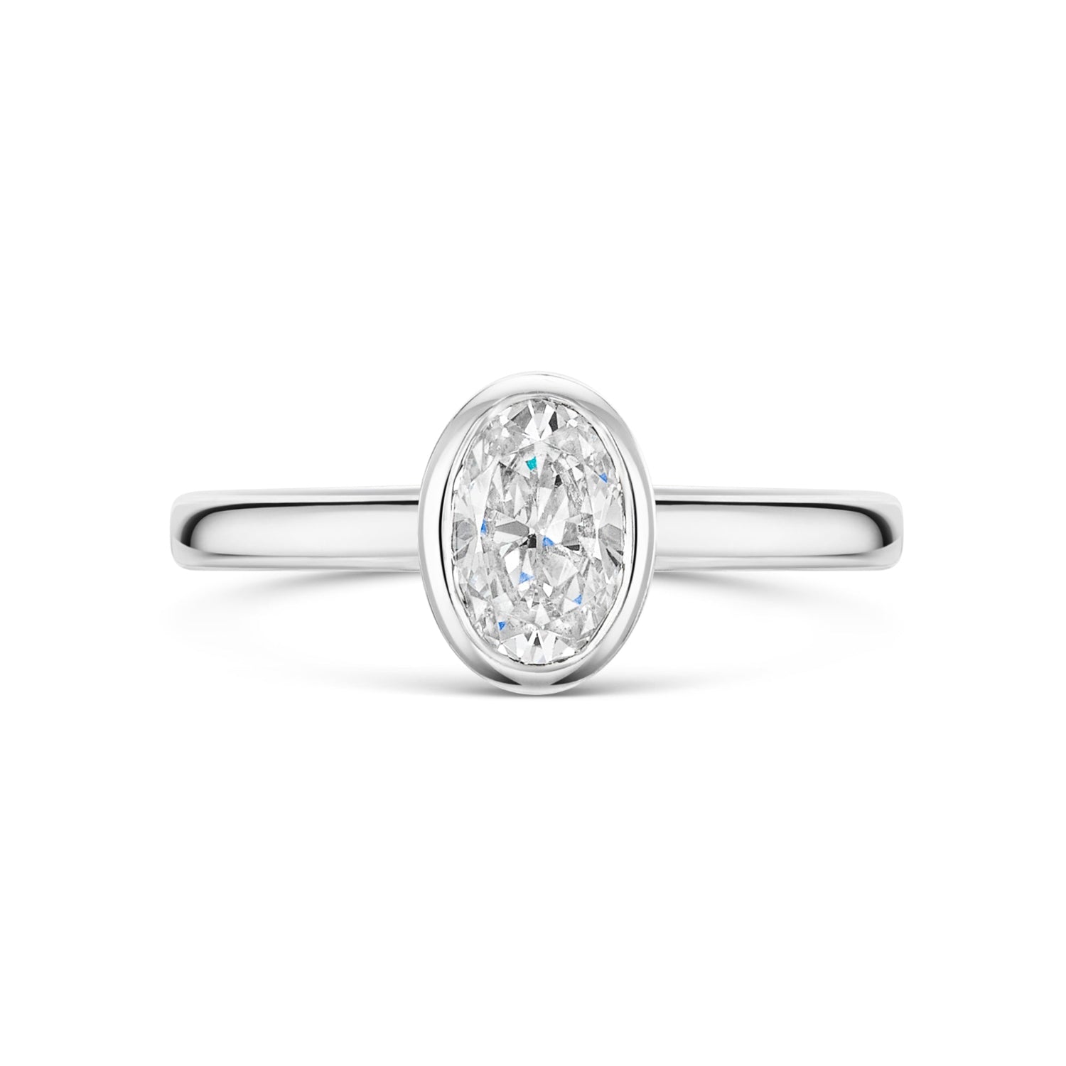 Oval Bezel Set Diamond Solitaire Engagement Ring in Platinum on a white background 