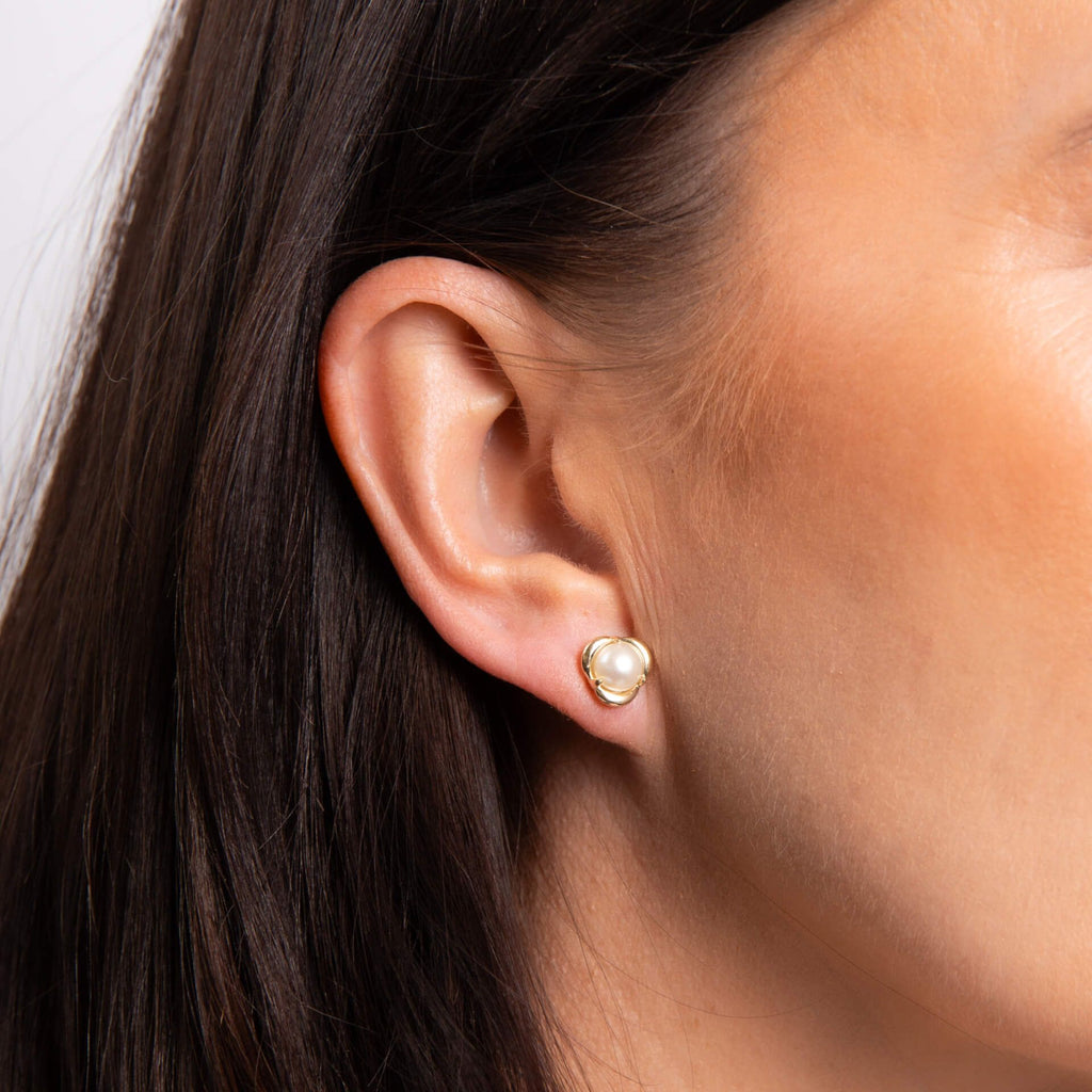 Pearl Petal Stud Earrings in Yellow Gold - close up on model with dark hair 