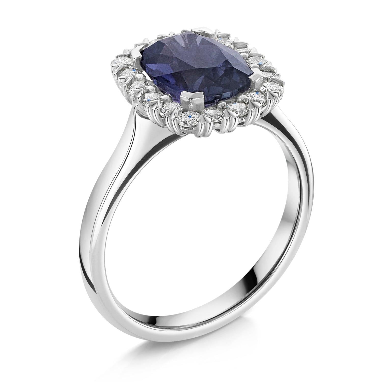 A silver-tone halo ring featuring a large, cushion-cut deep blue purple colour change sapphire center stone surrounded by a halo of small white diamonds, set against a plain white background - angled side view.