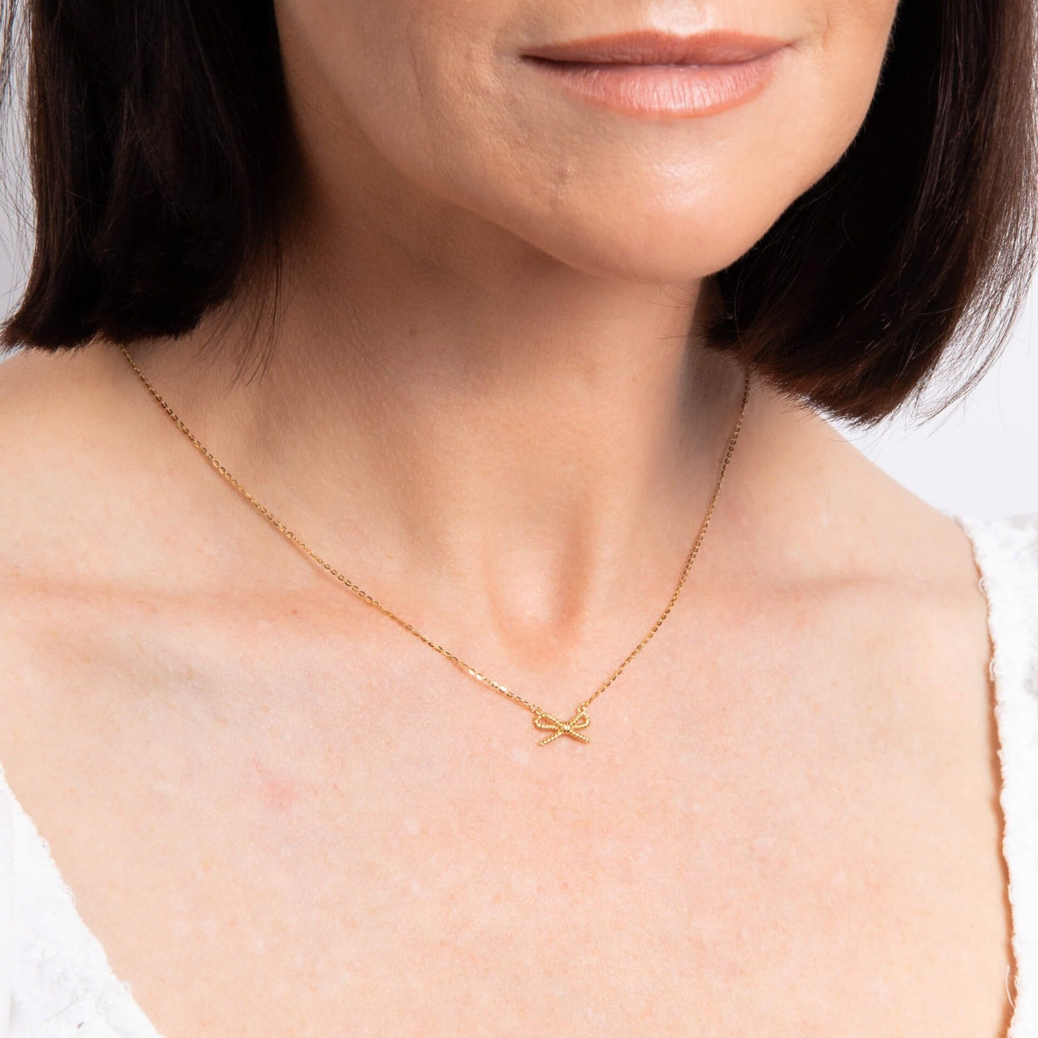 Rope Bow Necklace in 9ct Yellow Gold on model 