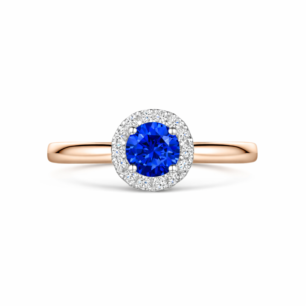 Round blue sapphire & diamond halo engagement In rose gold on a white background