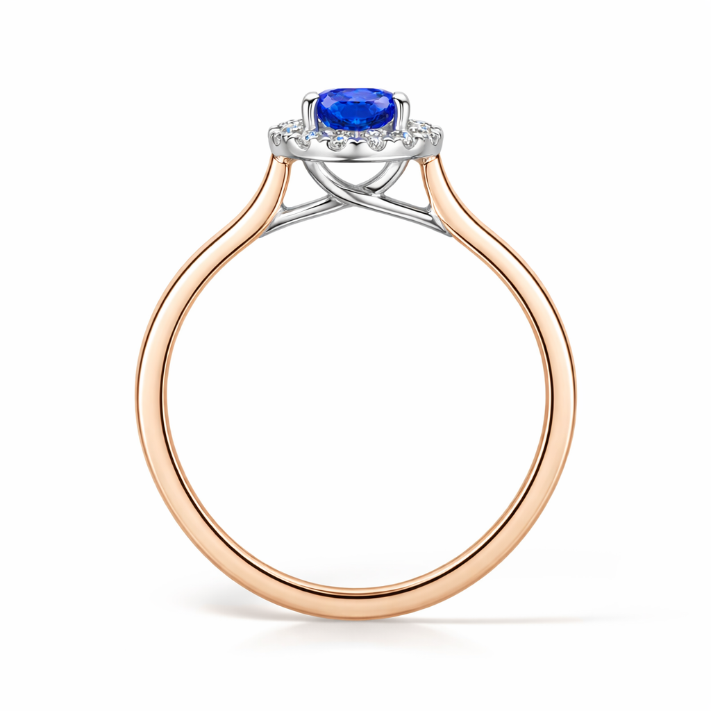 Round blue sapphire & diamond halo engagement in rose gold - side view on a white background