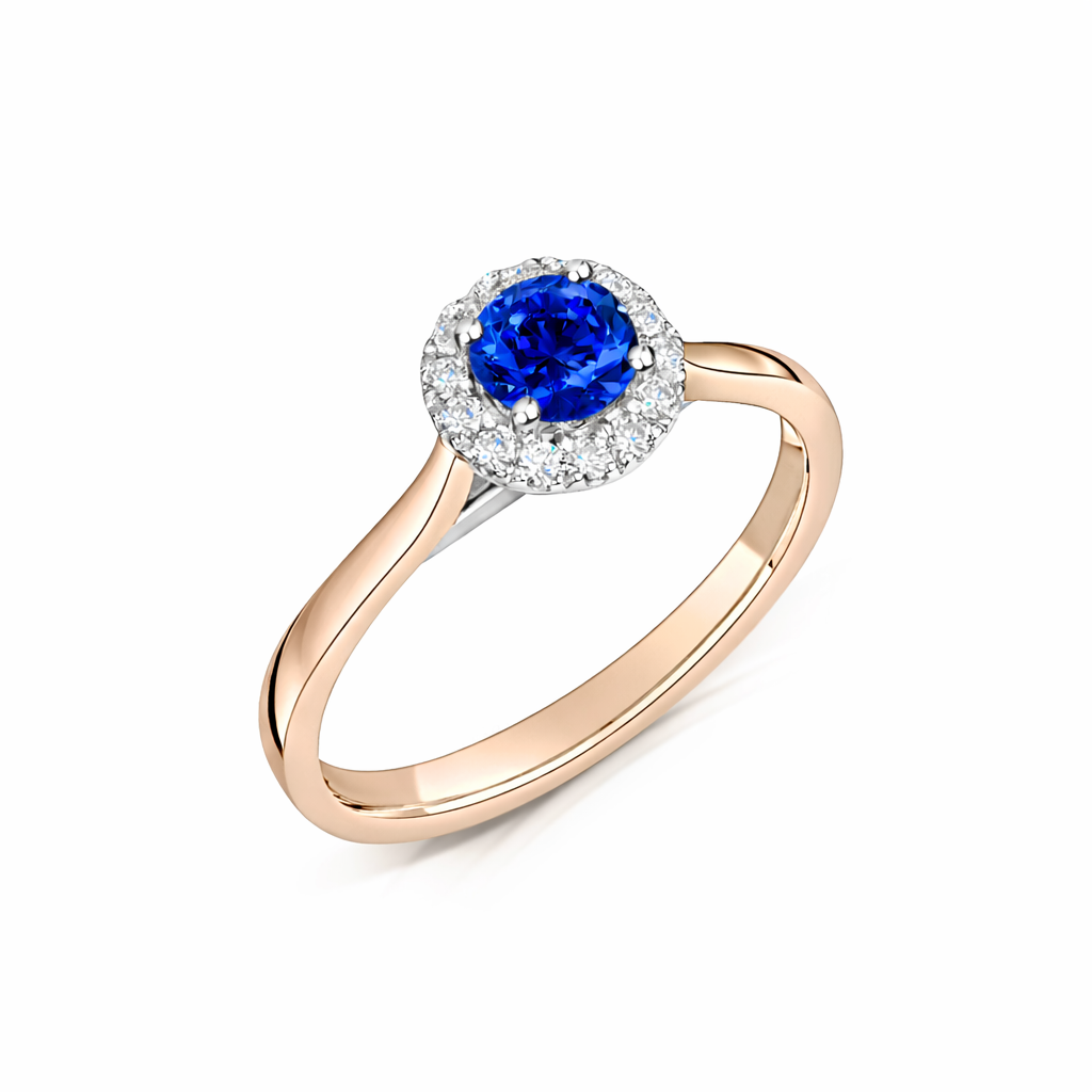 Round blue sapphire & diamond halo engagement in rose gold - angled view on a white background