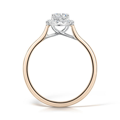 Round diamond halo engagement ring in rose gold - side view on white background 