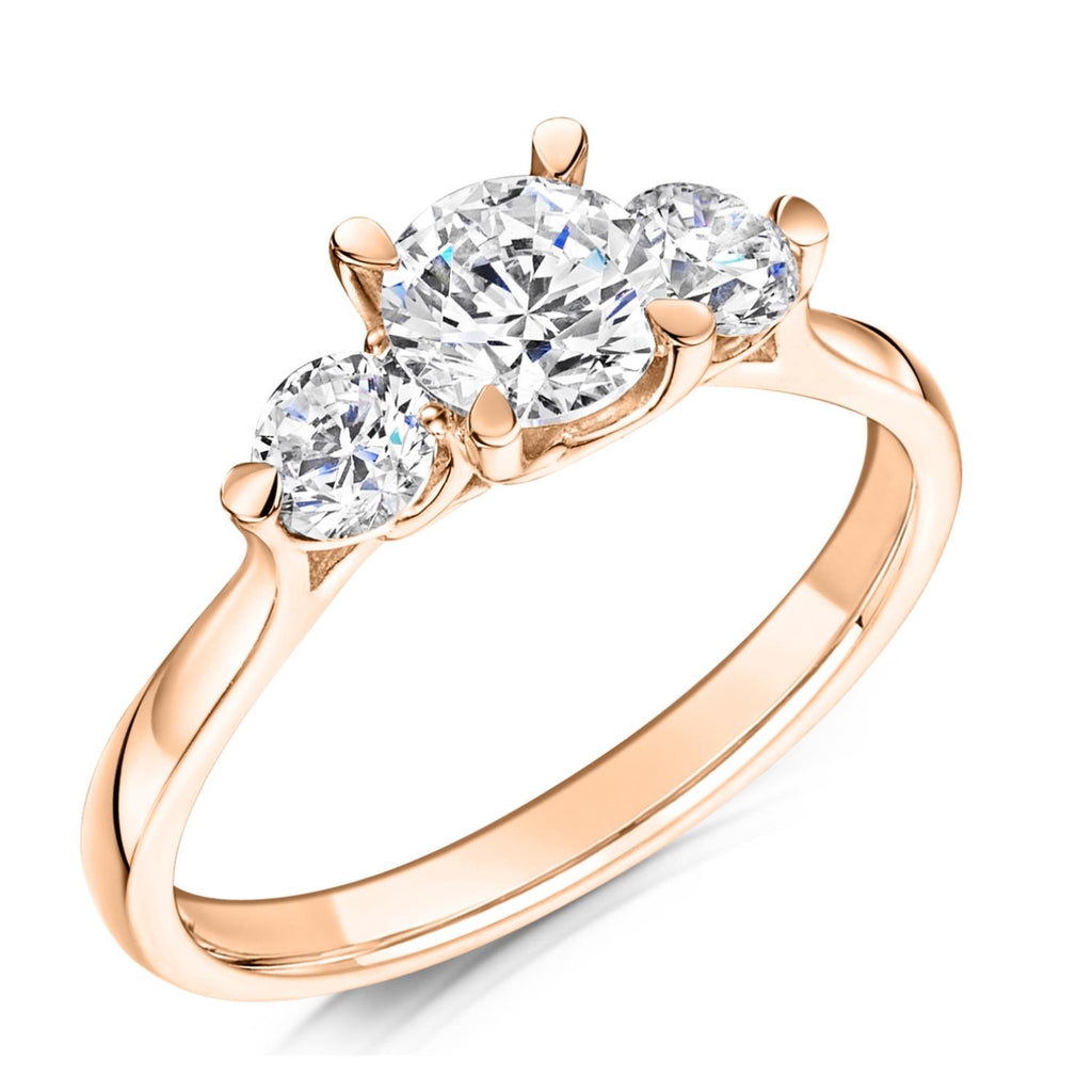 Rose gold ring with three diamonds on a white background