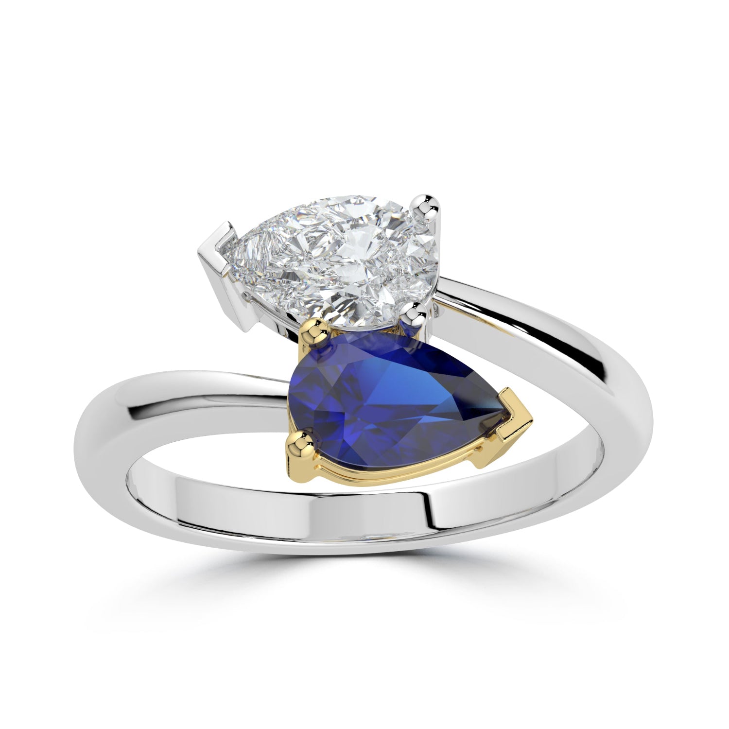 Ring with pear-shaped diamond and blue gemstone on a white background