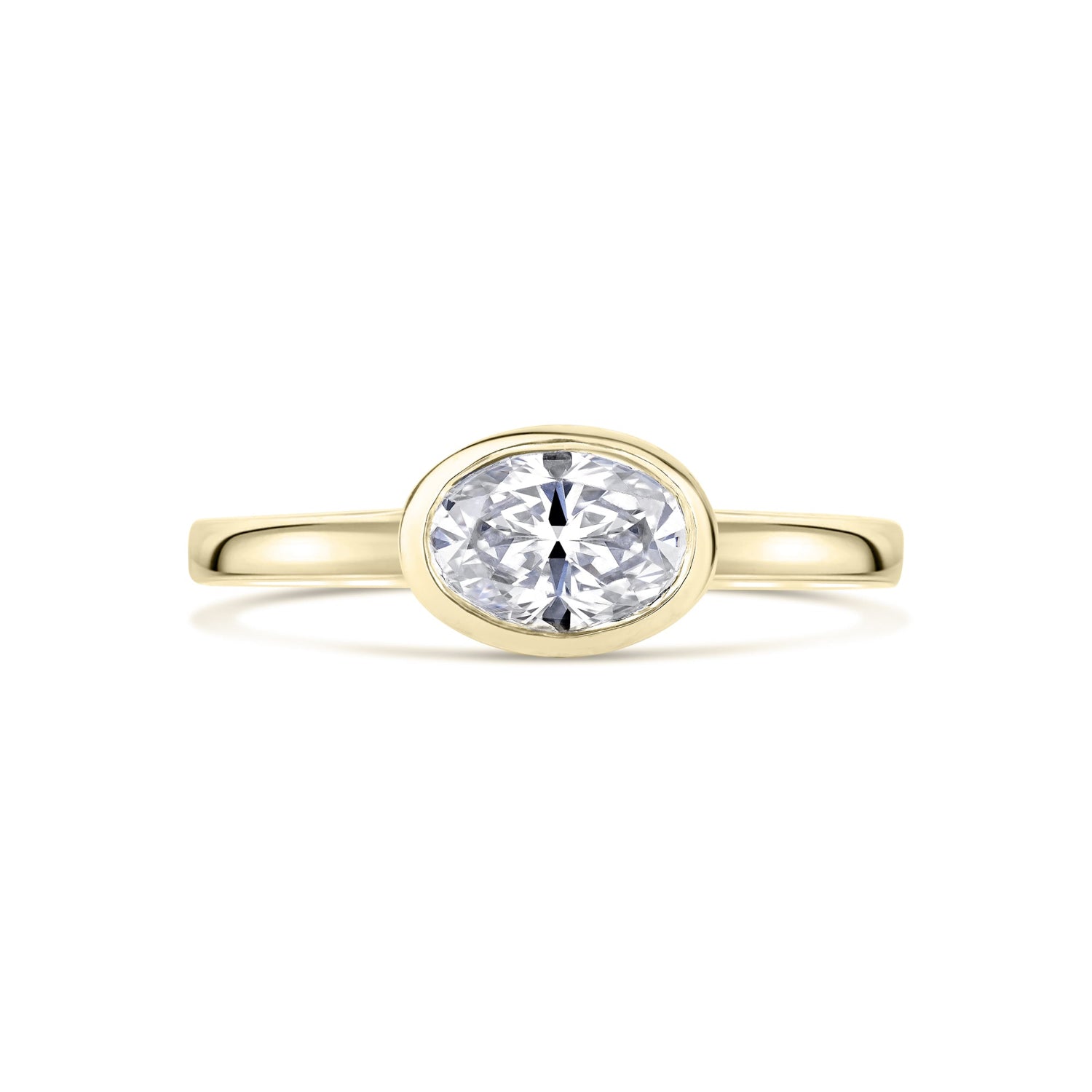 Yellow Gold Oval East West Bezel Set diamond Ring on a white background