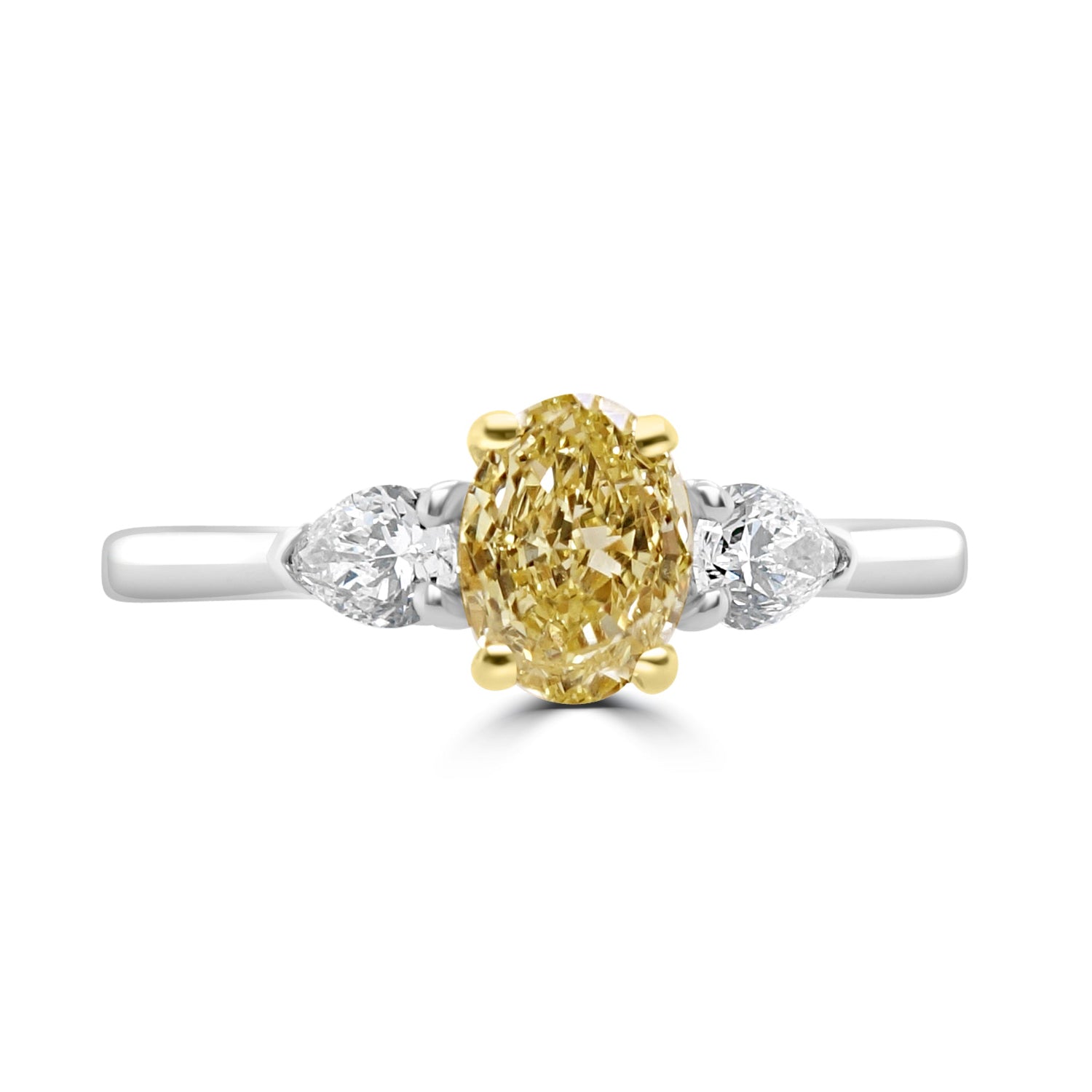 Yellow Oval Diamond Trilogy Engagement Ring with Pear Shaped outer white diamonds on a white background