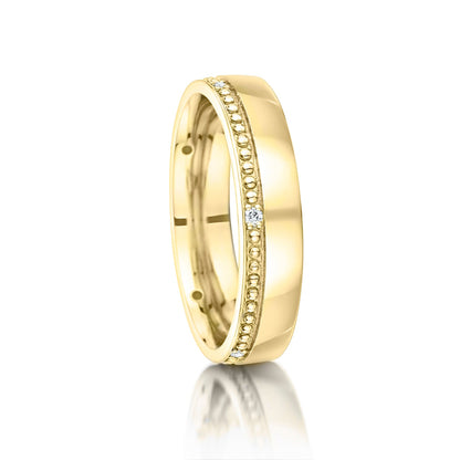 Gold ring with diamond accents on a white background