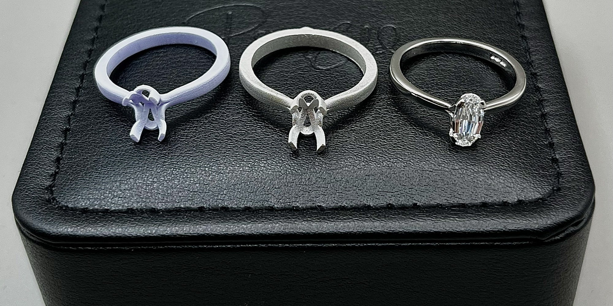 Three stages of a bespoke engagement ring - wax, casting & finished diamond ring.