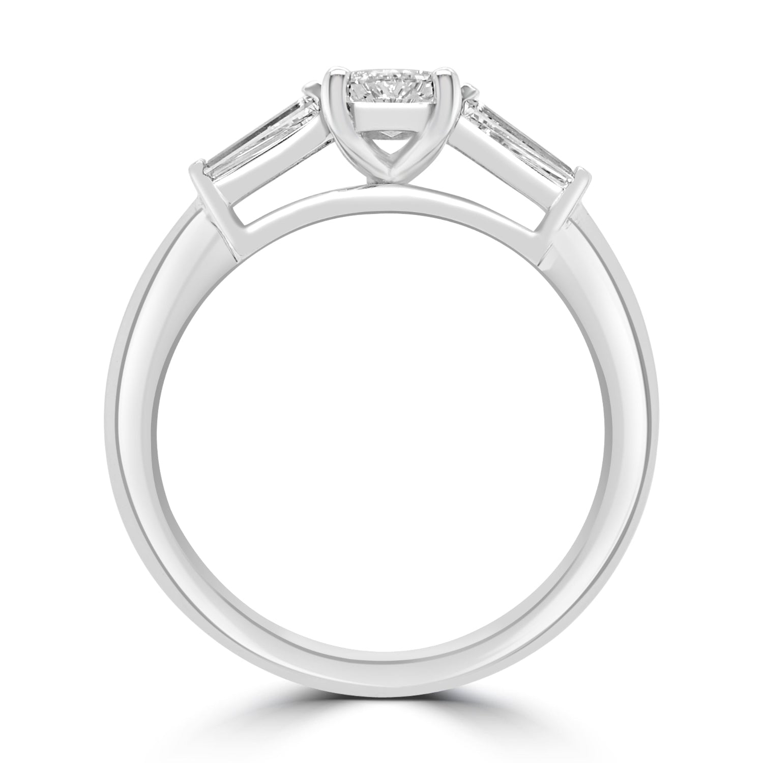 step cut oval diamond trilogy ring with tapered baguettes - side view on white background