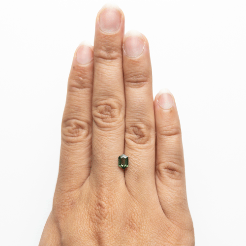 0.87ct Green Sapphire in Hexagonal Shape on a hand for size