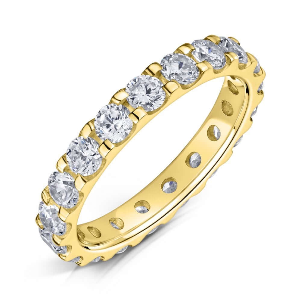 3.0mm Yellow gold eternity ring with round diamonds set all the way around on a white background.