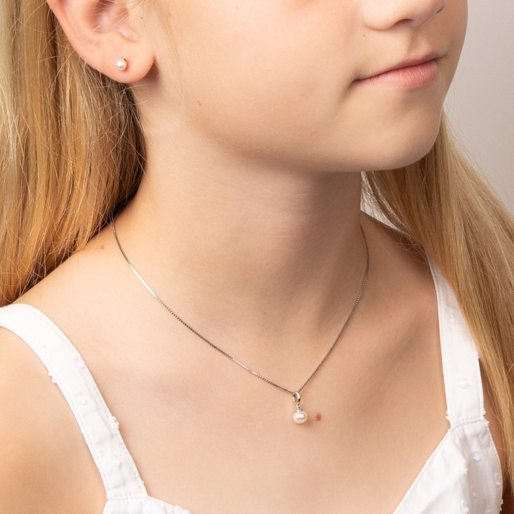 Children's Pearl & Diamond Earrings and matching necklace being worn by little girl.